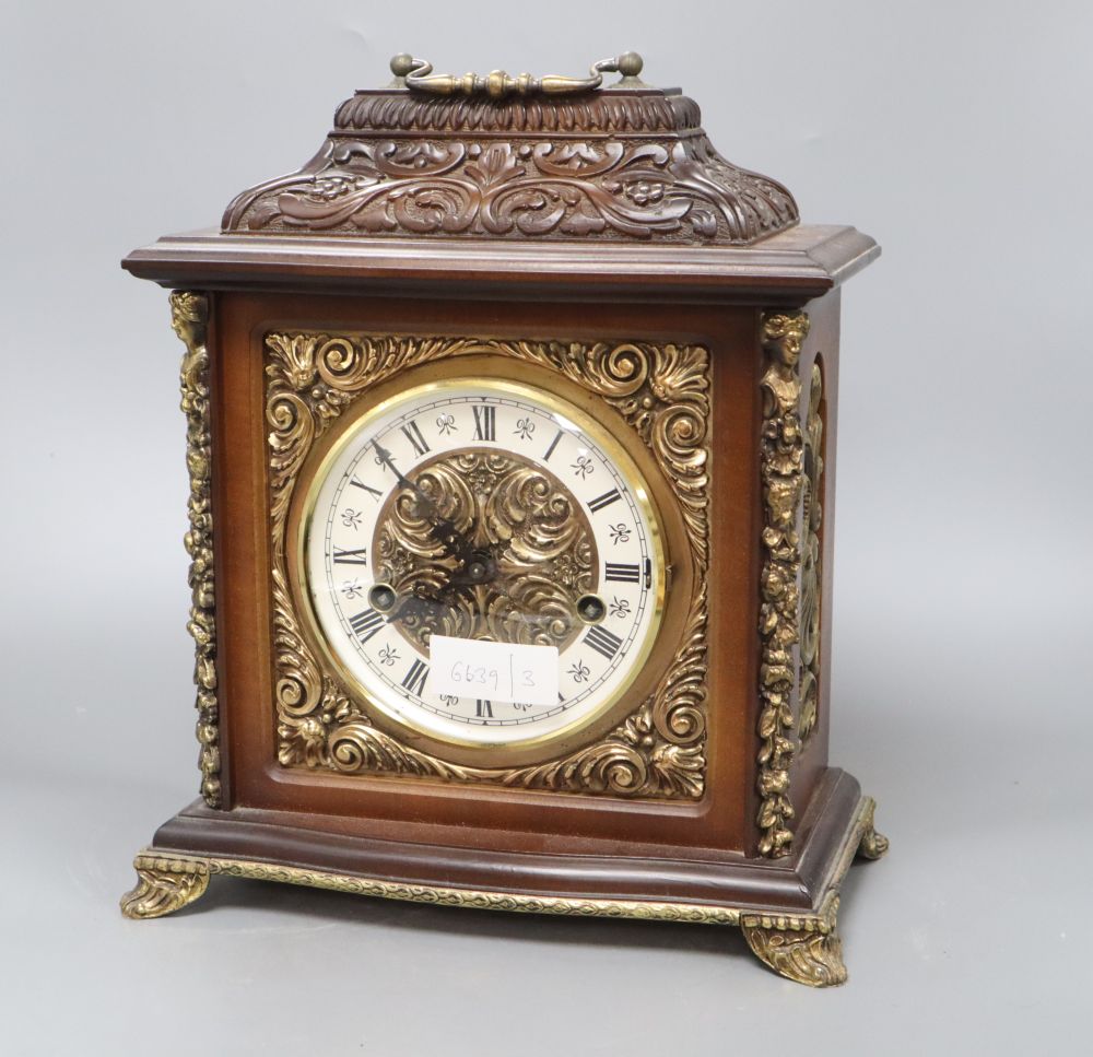 A German ornately carved and brass mounted mantel clock, height 34cm